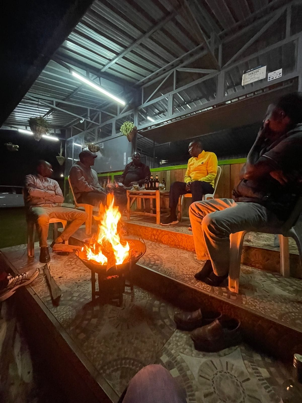 People enjoying live acoustic music around bonfire